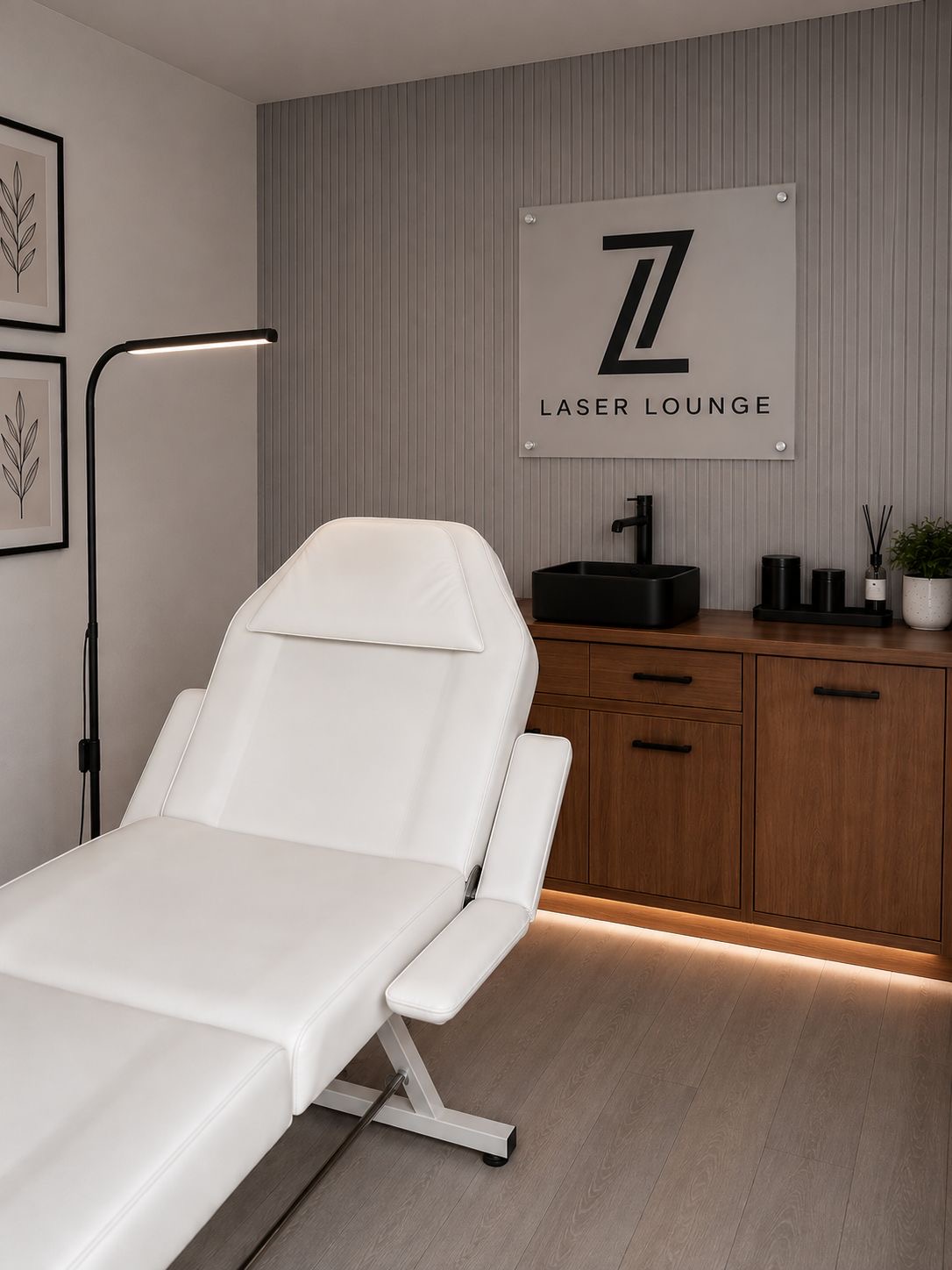The Laser Lounge treatment room with treatment chair and branding